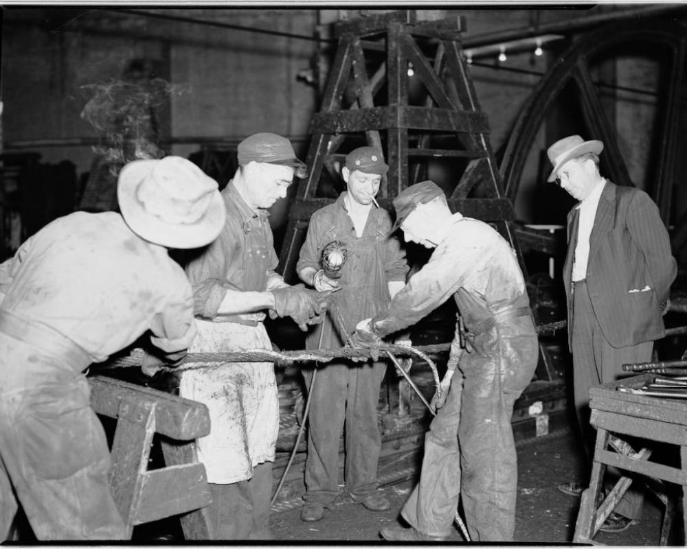 Four men splicing a cable 