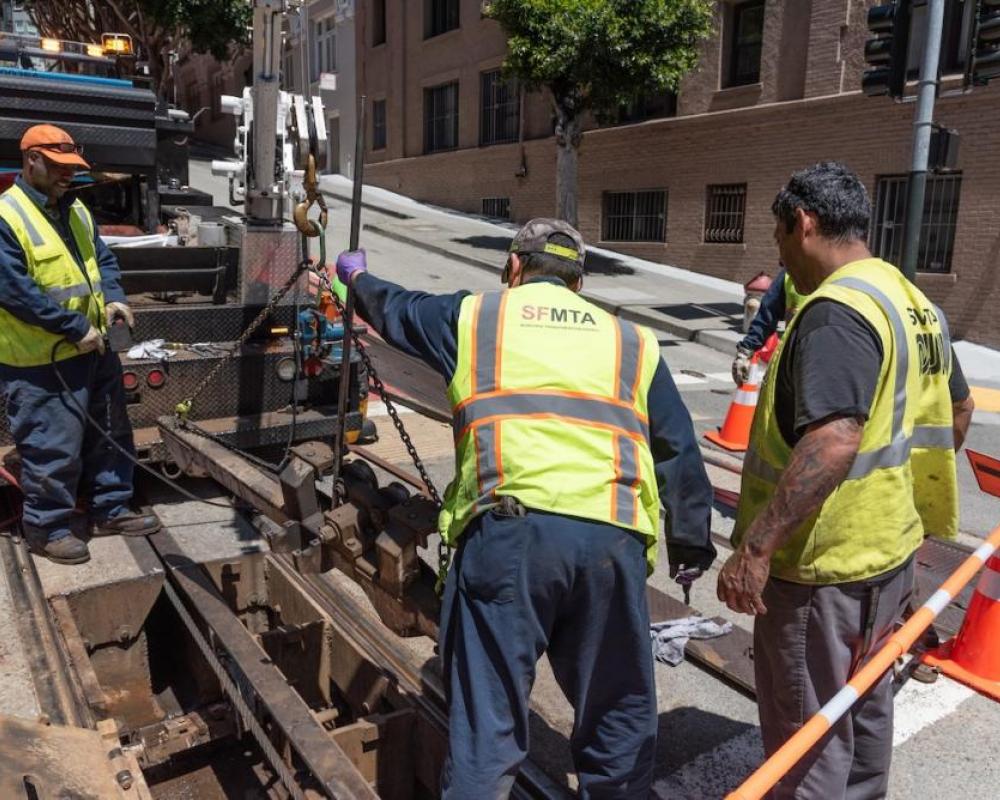 a track crew replaces an old depression beam