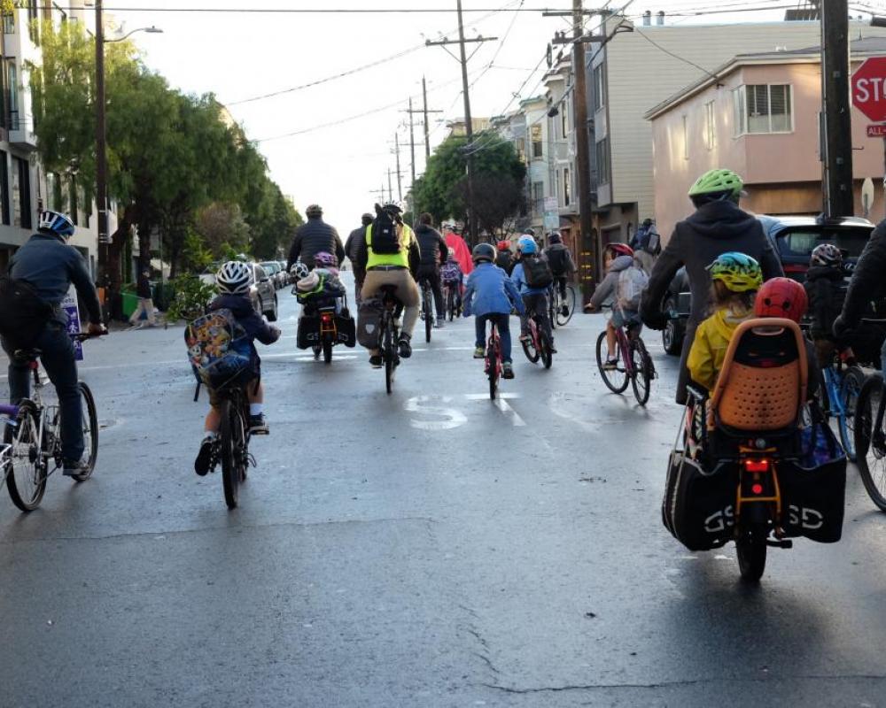 Kids and people biking on Page Slow Street on their way to school