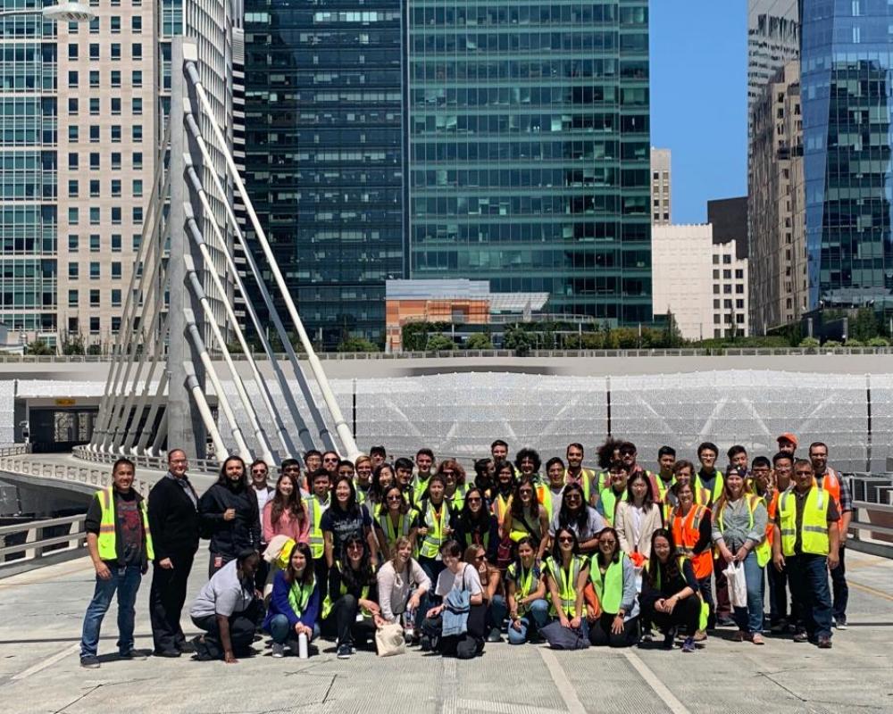 Photo of tour group on bridge with Salesforce Transit Center in the background.