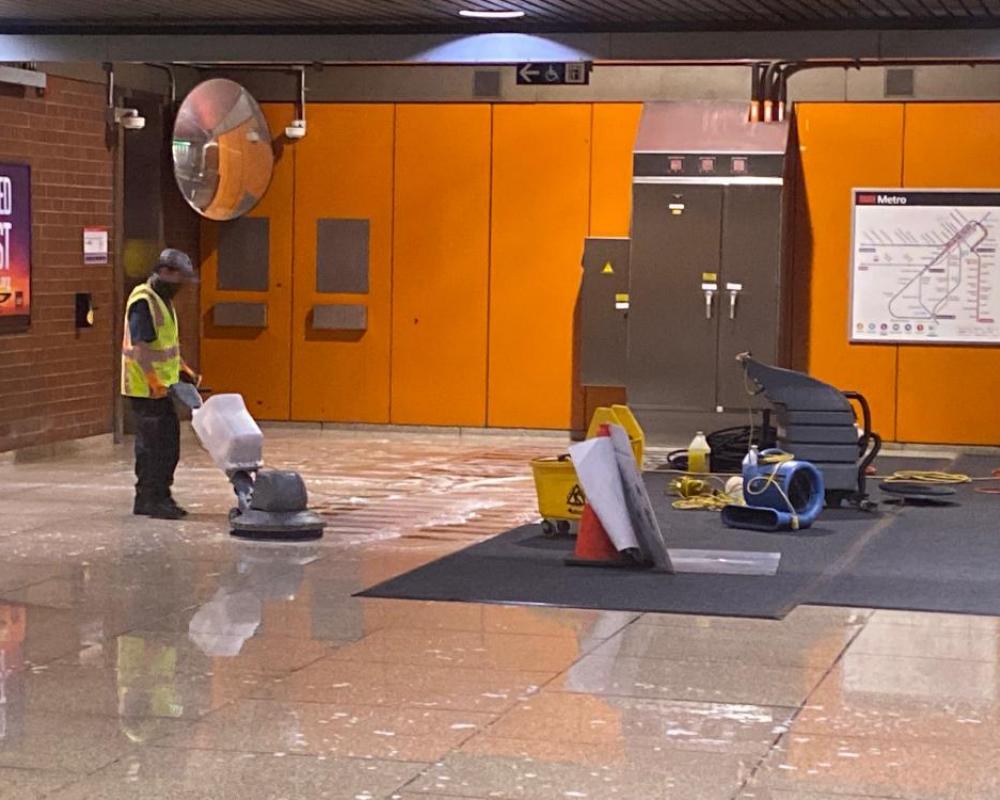 Custodians from Buildings and Grounds make the floor shine at Castro Station