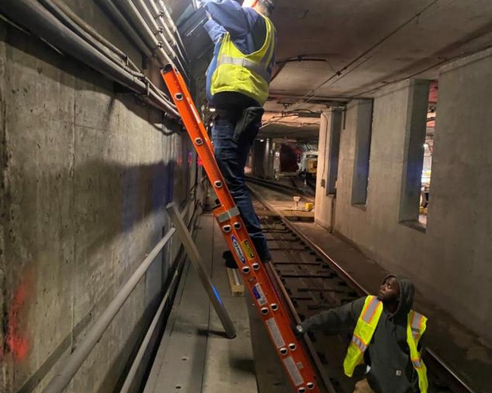 Subway engineers from Mechanical Systems restore and replace lighting systems throughout the tunnel