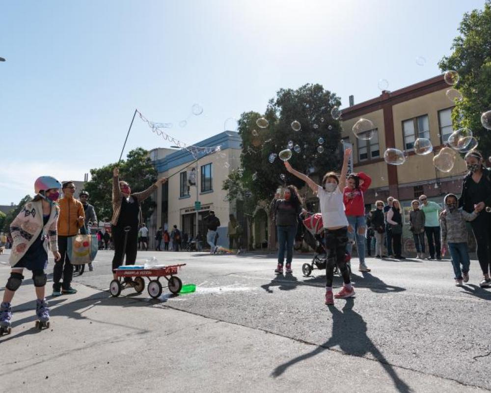 Children and families celebrate open streets in San Francisco during Phoenix Day.