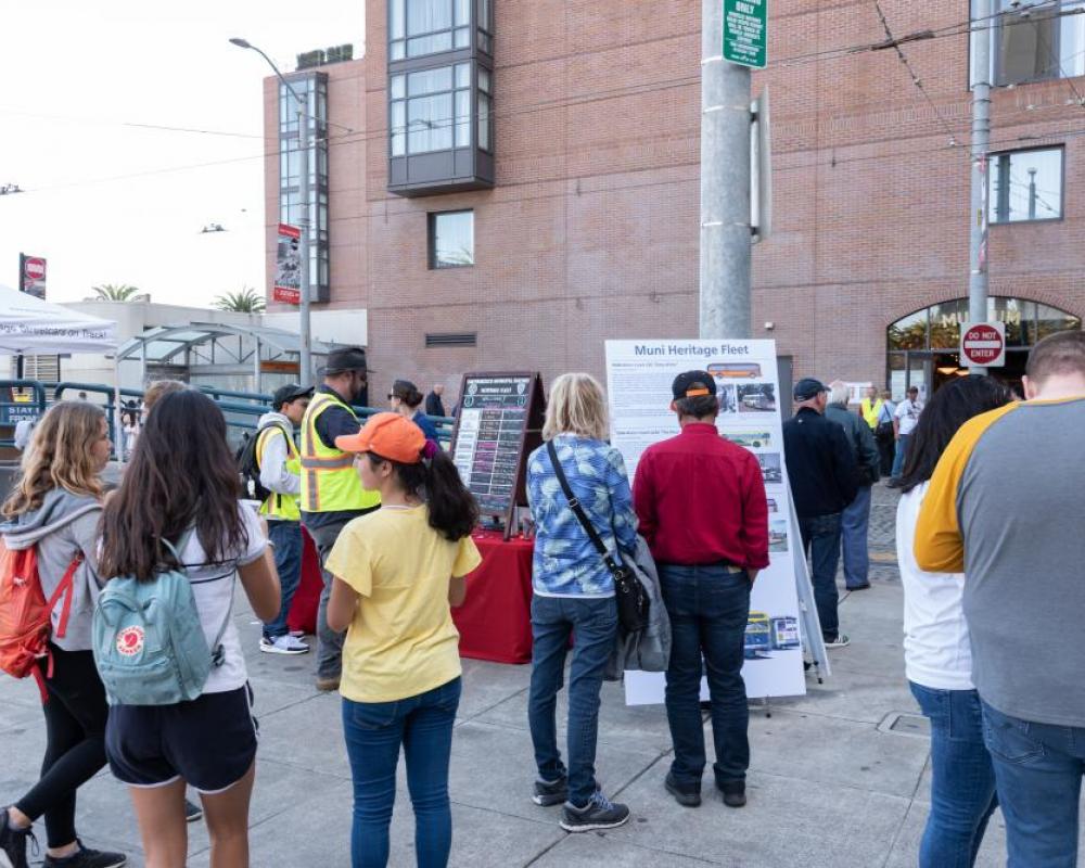 Event attendees visiting a Muni Heritage booth