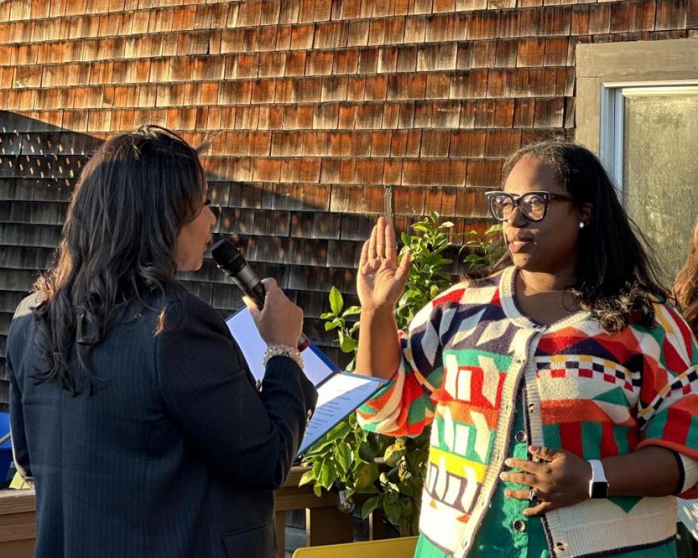 San Francisco Mayor London Breed and Board of Directors member Dominica Henderson facing each other at a swearing in ceremony. 