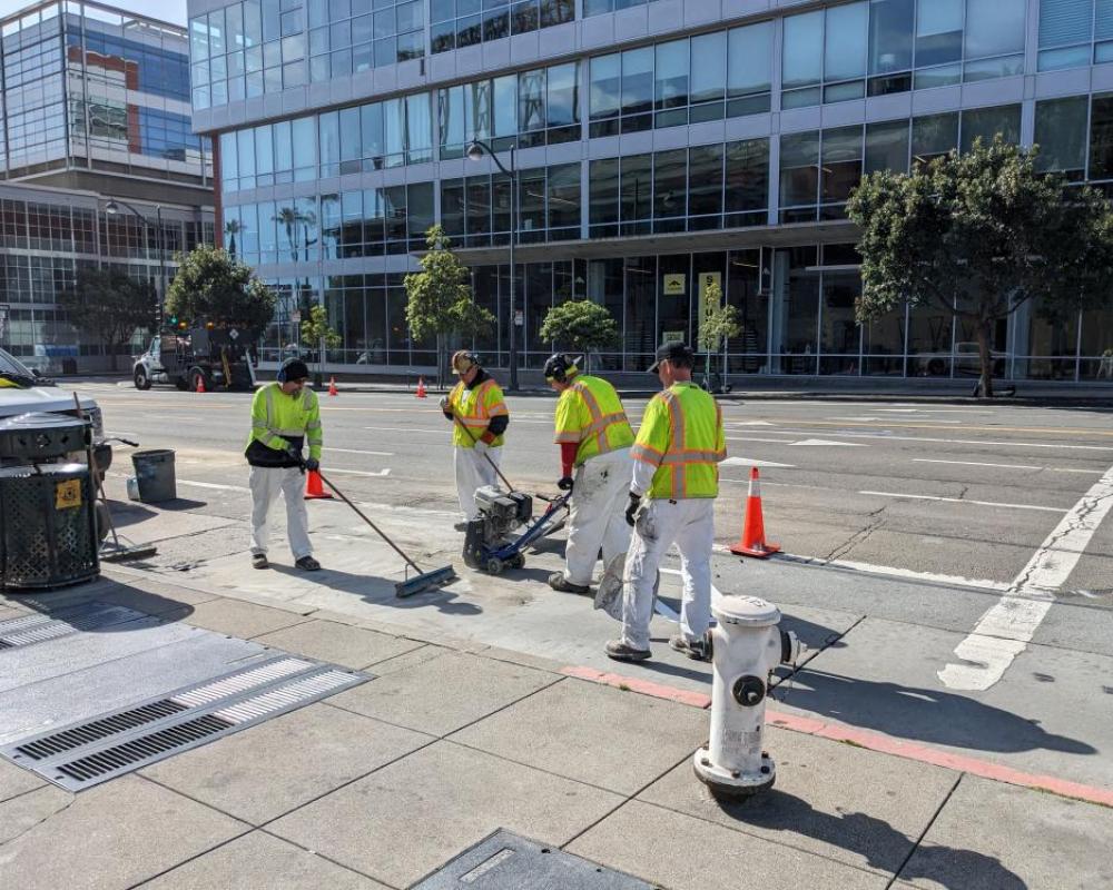 SFMTA Painters grinding out previous roadway striping in preparation 