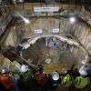 Project and agency staff watch TBM Big Alma emerge inside the North Beach retrieval shaft in 2014.