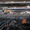 A worker walks atop the rebar cage of the invert slab at the north end of the Union Square/Market Street station box.