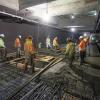 A crew pours concrete around future elevator footings inside the Yerba Buena/Moscone station box.
