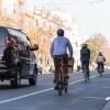 People biking and driving on Valencia Street