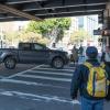 pedestrians walking in the crosswalk at 13th Street and Mission Street and a turning pick-up truck