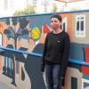 Artist Emily Fromm with her mural "East West Portal"