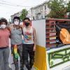Simón Malvaez with friends in front of his mural "Them (Ramp)"
