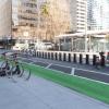 bike racks on the sidewalk, protected bikeway, and bikeshare station