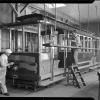  Two painters work on California Street Cable Car 15 in the paint shop