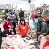 SFMTA staff hand out Muni bags to guests at the Geary Rapid ribbon cutting event