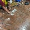 Dan Alger from mechanical system group replaces worn and broken floor tiles