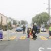 Kids cross Slow Hearst on their way to school.