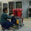 A man is kneeling in front a deck system piece inside a shops location.