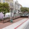 Accessible boarding ramp at street level with trees planted nearby. 