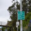 Directional bike signage, 40 MPH sign, and  St. Mary's Park Footbridge