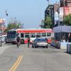 19 Polk Bus turning onto Beach Street while a biker bikes and passenger loading occurs in front of Ghirardelli Square