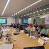 a group of people sitting at a conference table. The Working Group met the developer team in Dec 2022.