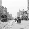 Looking west on Market Street from 3rd Street with a cable car on the left and a waiting station on the right in January 1906.