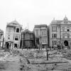 black and white photo of houses damaged and leaning after the 1906 earthquake and fire