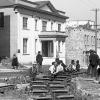 black and white photo of men working on rails in the street