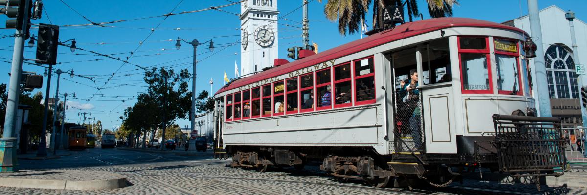 grey and red muni streetcar 1 near ferry building on embarcadero