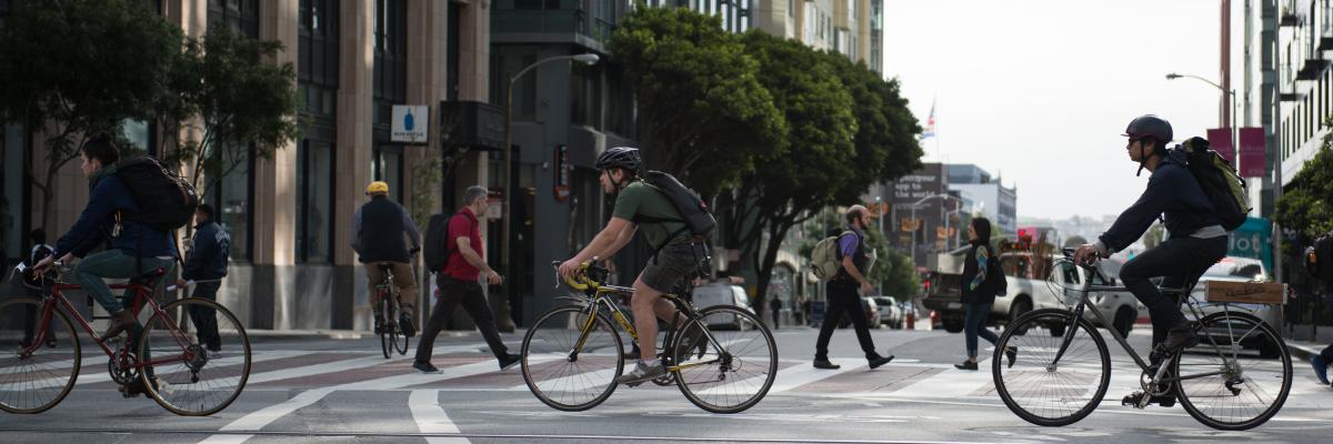 People biking east  bound on Market St at 10th St