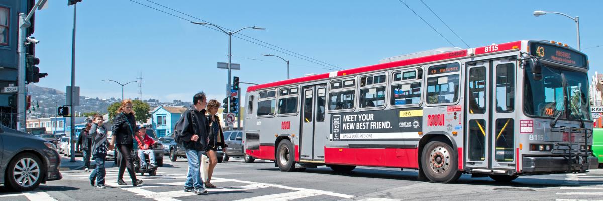 A crosswalk in the Excelsior neighborhood with pedestrians and a Muni bus passing by in 2016