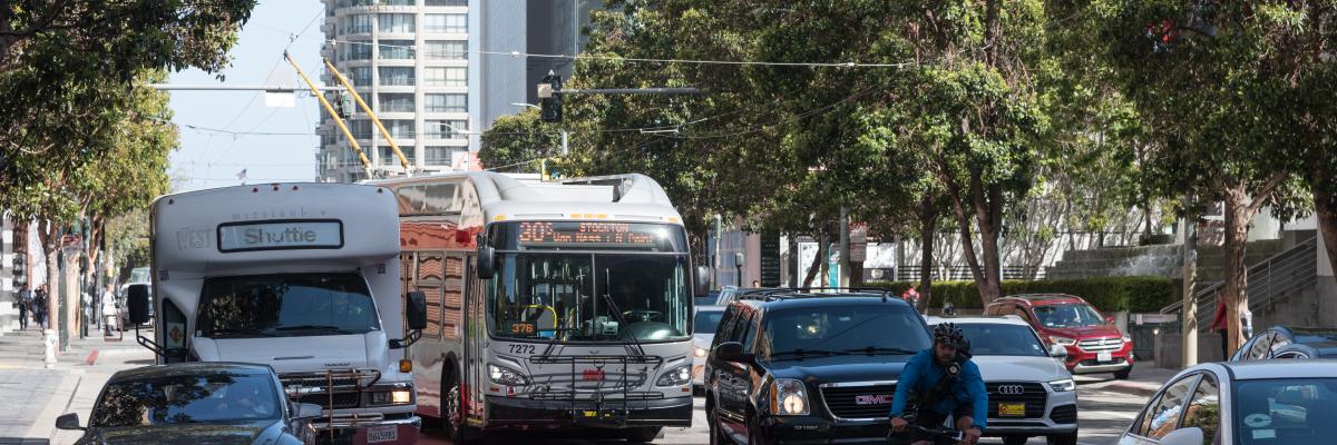 30 Stockton bus traveling north on Third Street. Driving in the red transit lane, the bus is blocked by vehicles turning right.