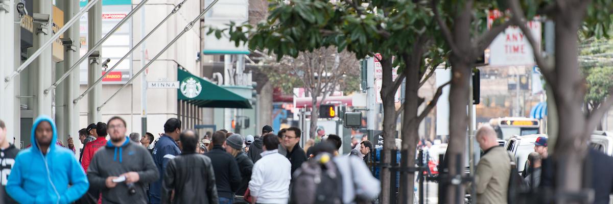 People walking along a busy sidewalk in SOMA