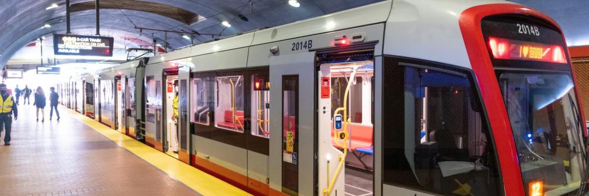 Photo of a Muni Metro LRV train with doors open on a subway platform.