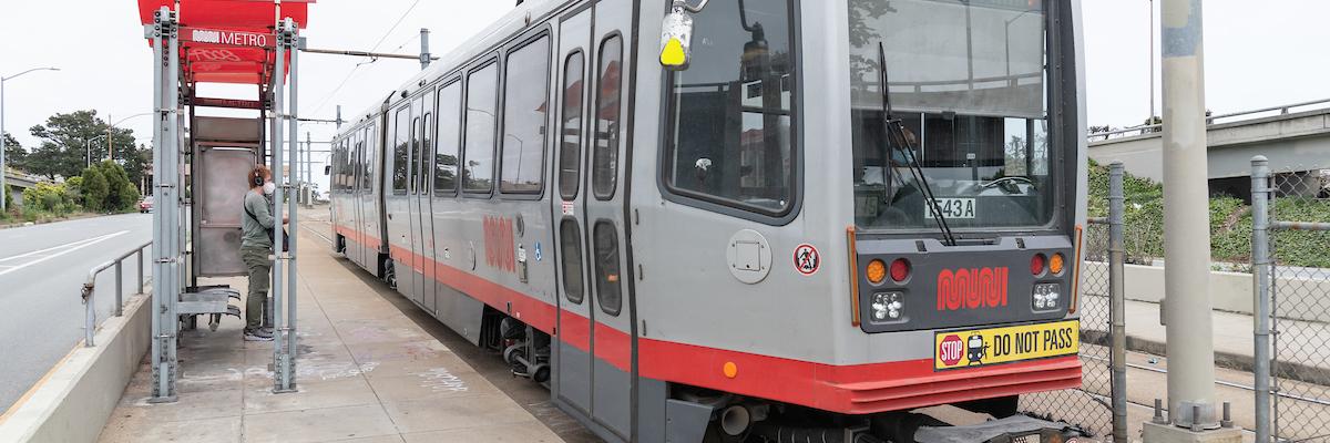 J Church train waiting at stop for customer to board. 