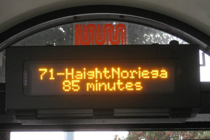 Digital screen at a Muni shelter showing the next bus arrival time.