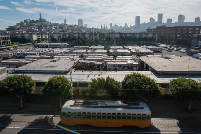 View overlooking Muni's Kirkland bus yard in Fisherman's Wharf, with a historic streetcar on Beach Street in front.