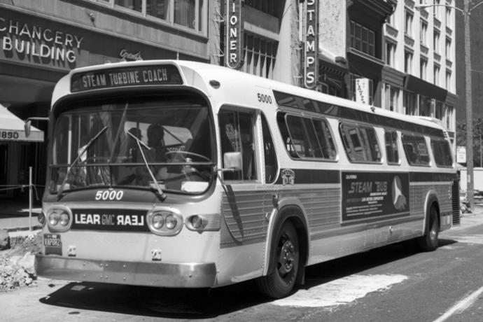 Black and white photo showing a GMC brand bus on Market Street near. Headsign reads Steam Turbine Coach.