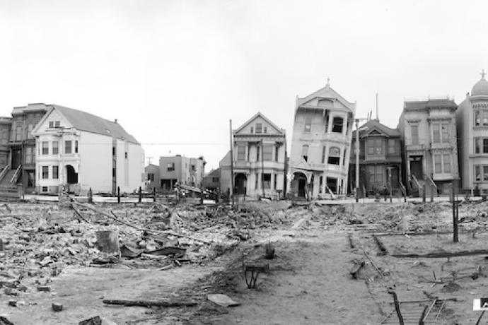 Historic photo showing damaged houses, leaning on South Van Ness taken May 1906 after great earthquake and fire.