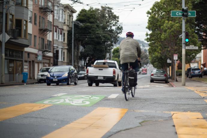 Man bicycling across Church street on 17th street