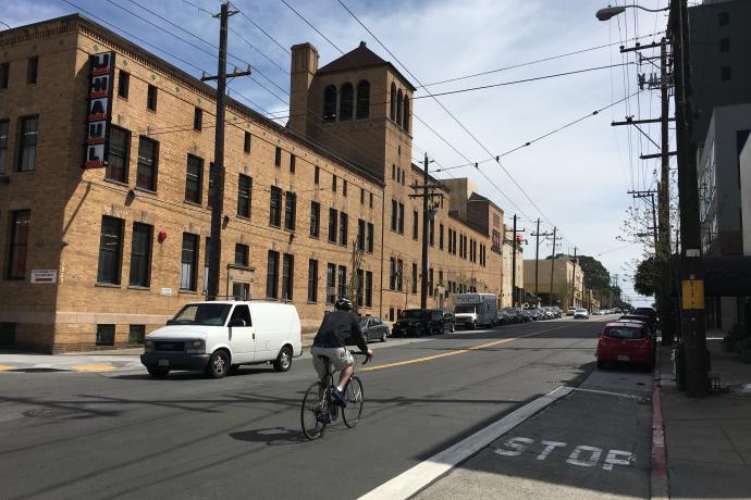 Person biking along Bryant Street travel lane