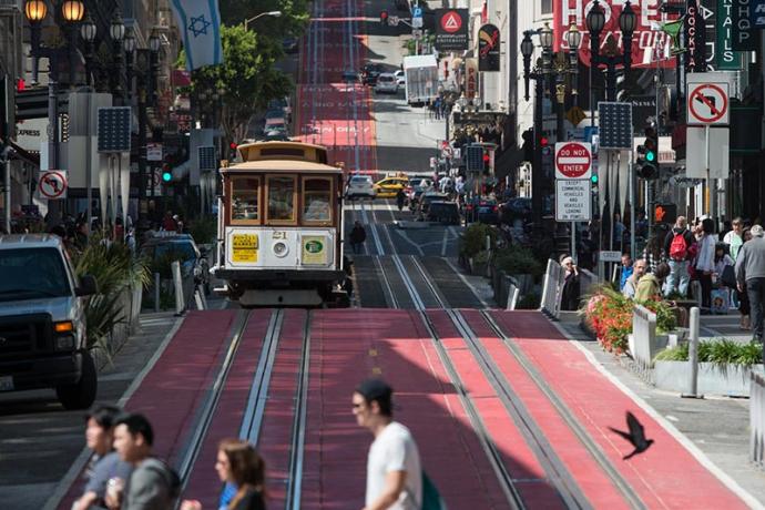 People crossing Powell Street, red lane pilot