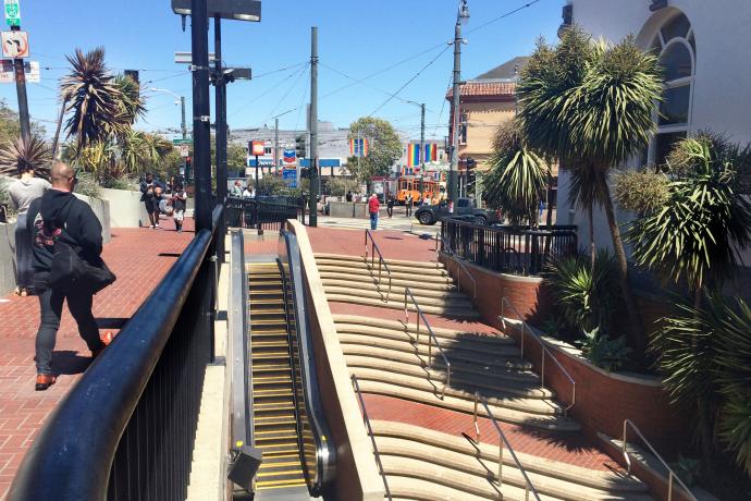 People walking around Harvey Milk Plaza and Castro Station entrance