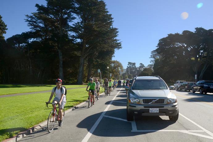 Photo of people bicycling on the parking-protected bikeway on JFK Drive.