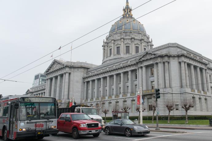 City Hall with Muni bus and traffic on van ness in foreground