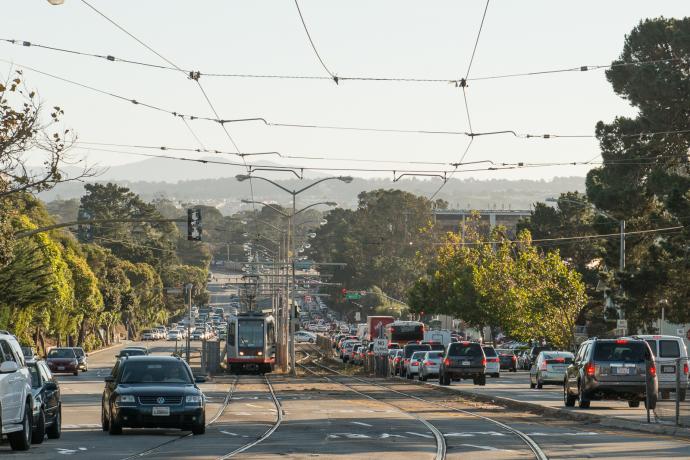 view of traffic and M Line train on 19th Avenue