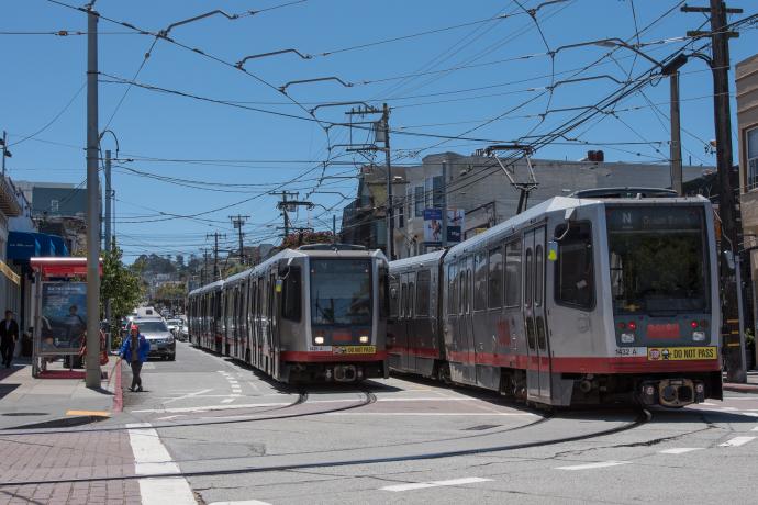 Two N Judah trains passing each other on 9th Avenue and Irving Street