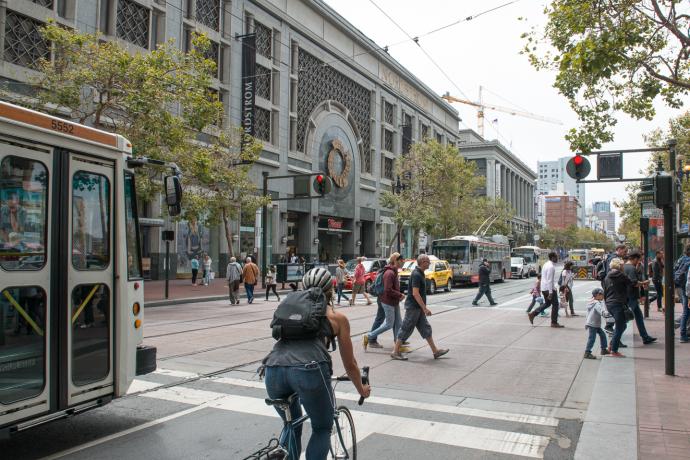 Pedestrians, cyclist, and Muni on Market Street near 5th